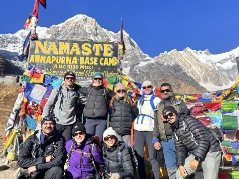 Trekkers at the Annapurna Base Camp sign in Nepal