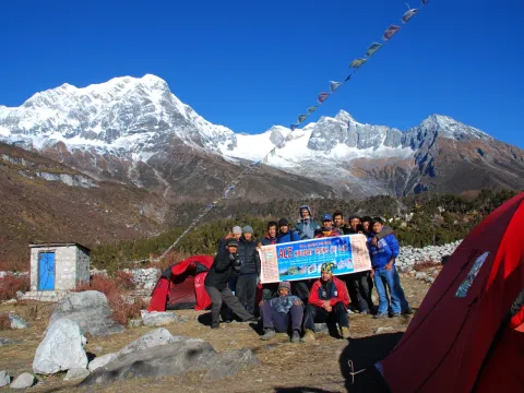 Group of trekkers posing with Himalayan mountains on the Manaslu Circuit Trek