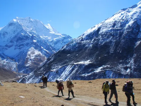 Trekker walking through the rugged mountain landscape on the Manaslu Circuit Trek in Nepal