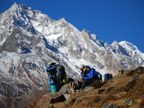 Group of trekkers admiring snow-covered Himalayan mountains on the Manaslu Circuit Trek